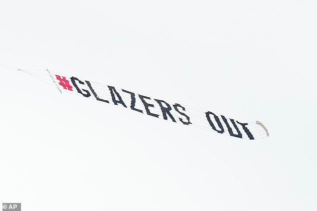Fans of Manchester United fly a banner reading “GLAZERS OUT” over Raymond James Stadium ahead of the Tampa Bay Buccaneers’ contentious match against the Philadelphia Eagles.