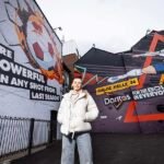 Chloe Kelly, England football star, aims to challenge stereotypes in women’s football after unveiling mural celebrating powerful penalty shot.